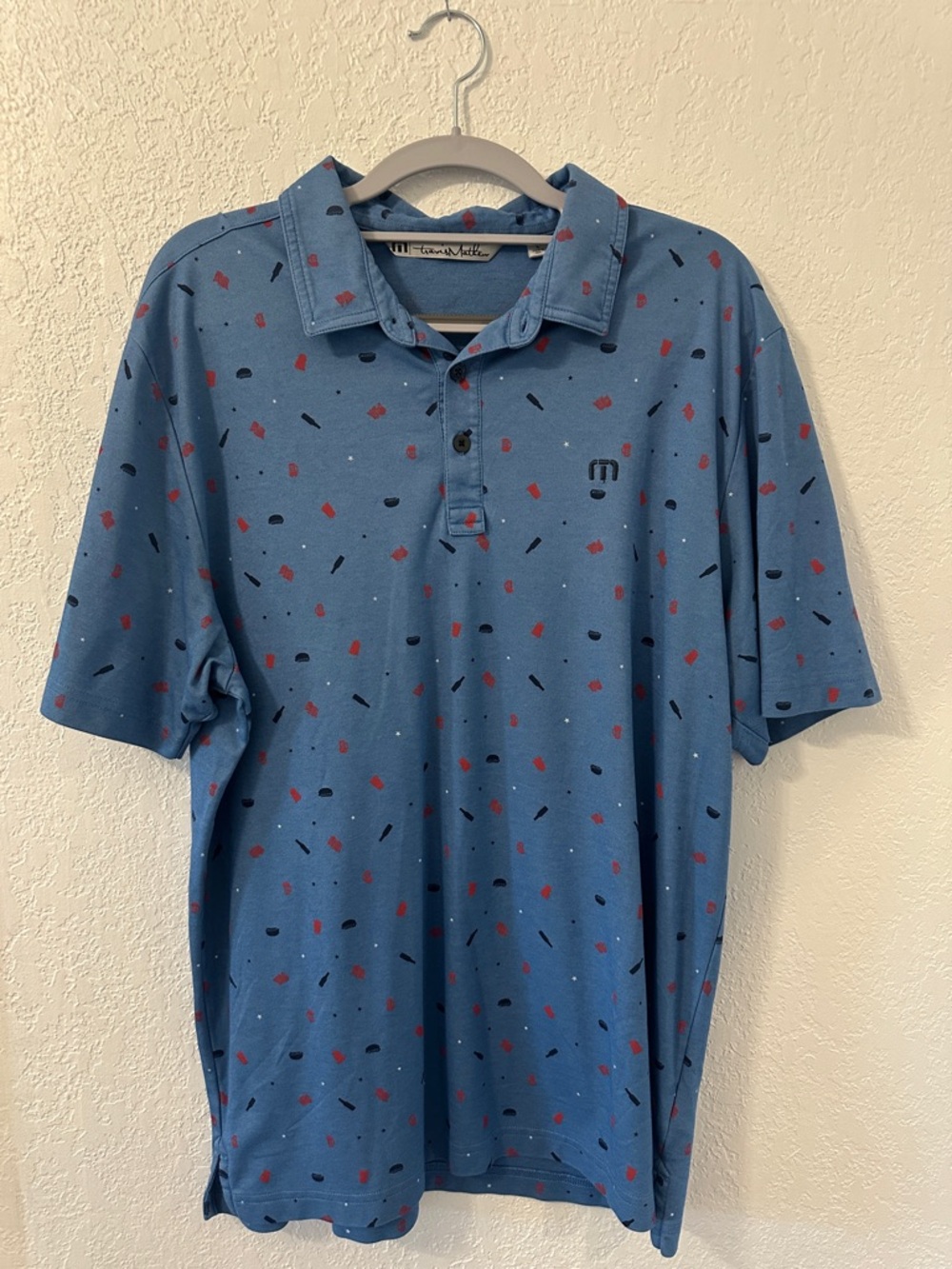 Travis Mathew 4th of July Light Blue Polo with Red & Black Print
